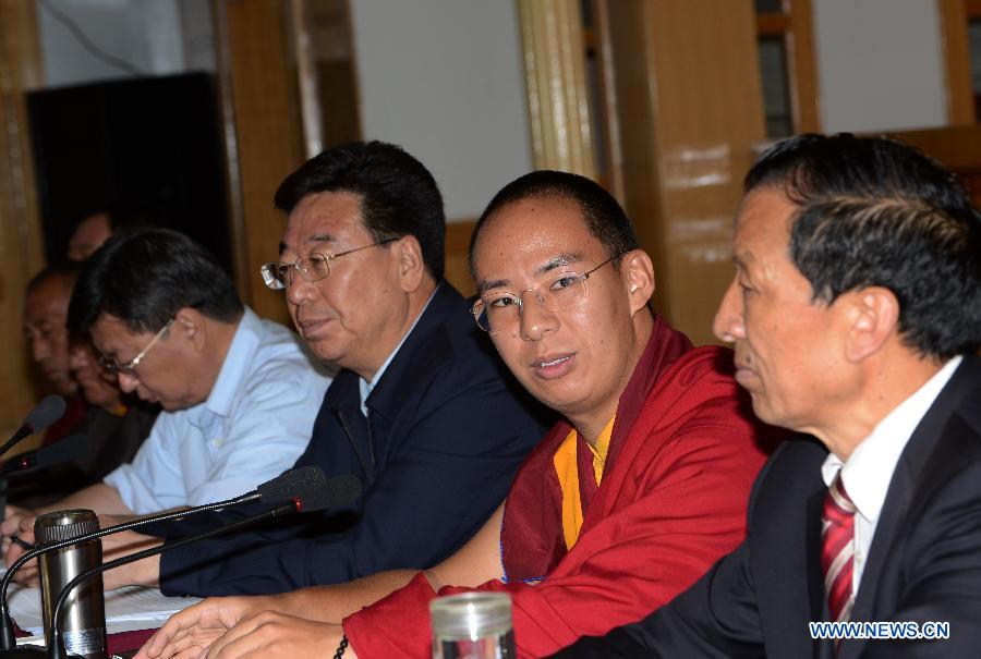 The 11th Panchen Lama Bainqen Erdini Qoigyijabu (2nd R), who is also a member of the Standing Committee of the Chinese People's Political Consultative Conference (CPPCC) National Committee, attends a symposium with CPPCC members in Lhasa, capital of southwest China's Tibet Autonomous Region, July 4, 2014. The Panchen Lama made a research and inspection tour in Lhasa in recent days. [Photo/Xinhua]