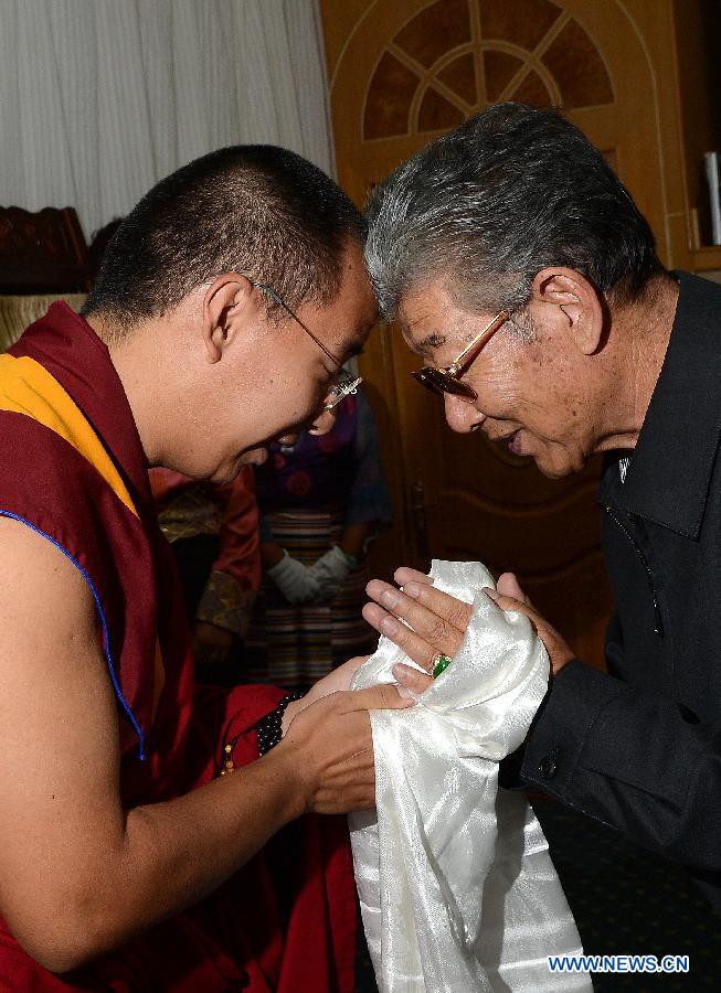 The 11th Panchen Lama Bainqen Erdini Qoigyijabu (L), who is also a member of the Standing Committee of the Chinese People's Political Consultative Conference (CPPCC) National Committee, greets top political advisor of Tibet Pagbalha Geleg Namgyai, who is also vice chairman of the CPPCC National Committee, in Lhasa, capital of southwest China's Tibet Autonomous Region, July 4, 2014. The Panchen Lama made a research and inspection tour in Lhasa in recent days. [Photo/Xinhua]