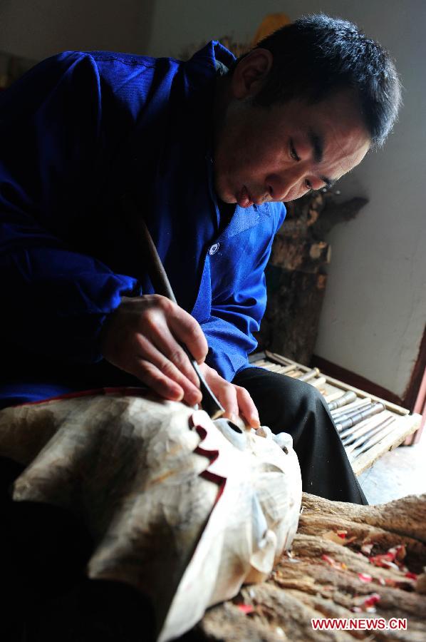 Folk artisan works on Nuo Opera masks