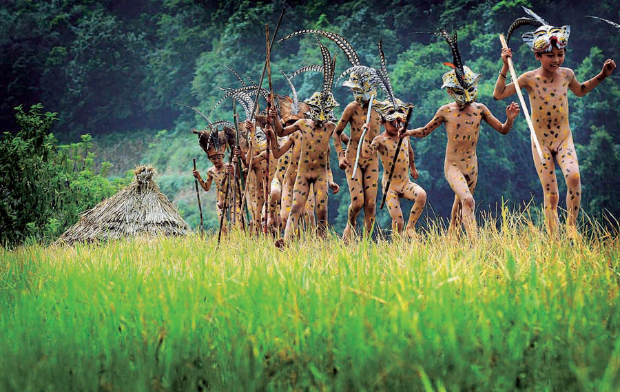 Naked boys of Yi nationality perform a leopard dance ceremony in Chuxiong Y...