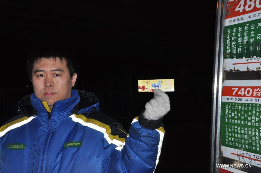 A bus worker shows a memorial bus ticket for the Year of the Horse in Beijing, capital of China, Jan. 23, 2014. Beijing Public Transport Holdings has issued a set of two memorial bus tickets for the Year of the Horse, or the lunar New Year, which begins on Jan. 31.
