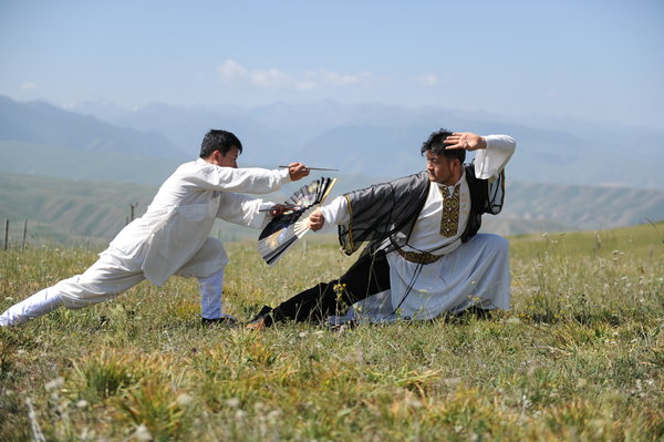 Martial arts masters display their skills during the Tianshan Mountain Cultural Week, August 3, 2013. 