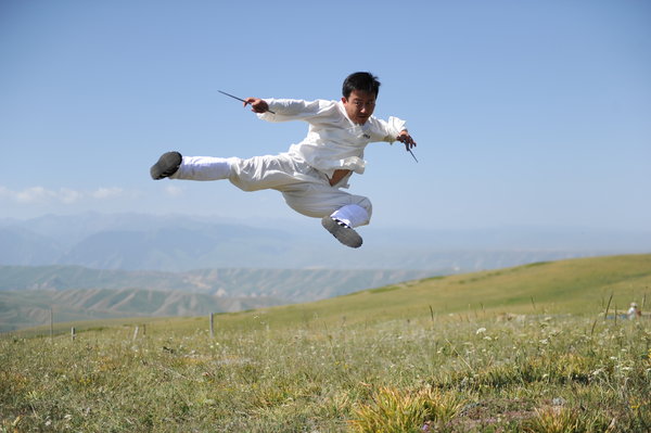 A master performs wushu during the Tianshan Mountain Cultural Week, August 3, 2013. 