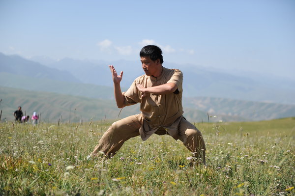 A master shows wushu during the Tianshan Mountain Cultural Week, August 3, 2013. 