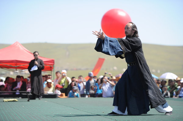 A tai chi master performs during the Tianshan Mountain Cultural Week in Tekes county, August 3, 2013. 