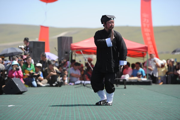 A master shows Wudang kung fu during the Tianshan Mountain Cultural Week in Tekes county, August 3, 2013. 